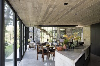 The home is an alternating series of open and enclosed spaces with ample glazing that provides plenty of natural light. 