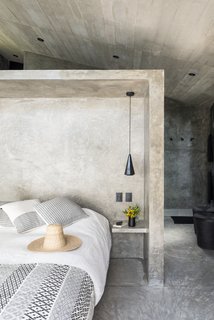 The bedroom is a good example of the minimal interiors featured throughout. 
