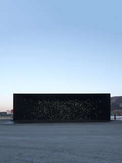 The structure has the appearance of a framed view into the depths of outer space.
