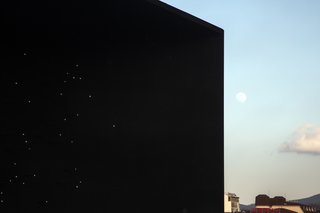 The black façade represents the Universe—the origin of Hydrogen. 