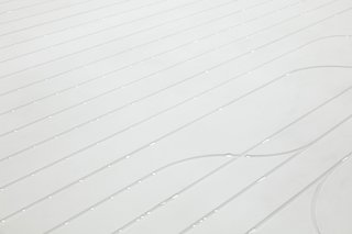 Visitors interact with sensors causing 25,000 water droplets to travel along the channels per minute.