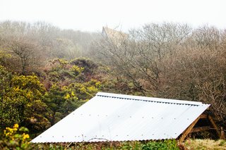 Go Off The Grid With These Remote Rental Cabins in Cornwall - Photo 12 of 12 - A view of the Kudhva rooflines against the Cornish countryside.