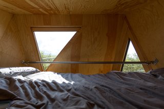Go Off The Grid With These Remote Rental Cabins in Cornwall - Photo 8 of 12 - The triangular windows let in breathtaking views of the Cornish countryside.