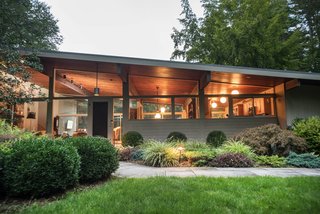 Own an Iconic Midcentury in New Canaan For $1.55M - Photo 2 of 12 - Two unique features of this home include the angled roof of the post-and-beam construction and the tongue-and-groove ceiling.