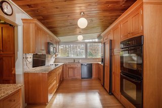 Own an Iconic Midcentury in New Canaan For $1.55M - Photo 8 of 12 - The kitchen also has plenty of stunning cabinetry, providing great storage space. 