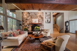 Own an Iconic Midcentury in New Canaan For $1.55M - Photo 5 of 12 - Another beautiful feature of the home is the stone fireplace. 