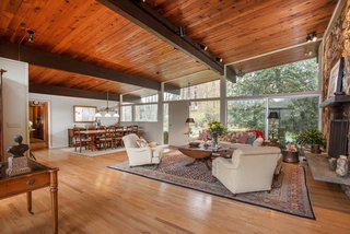 Own an Iconic Midcentury in New Canaan For $1.55M - Photo 4 of 12 - As you can see above, the living and dining area offers plenty of space for entertaining.