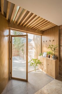 Floor-to-ceiling glass doors and windows keep the interiors bright and airy. 
