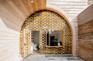 The main entrance of the cave was transformed into a wooden grid façade with a glass curtain wall, allowing ample natural light to enter the space. 