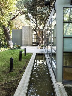 The International Style home boasts a glass, steel, and concrete construction.