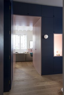 In the entryway, light is provided by a minimalist glass globe, and through another outlet that peeks into the living room. 