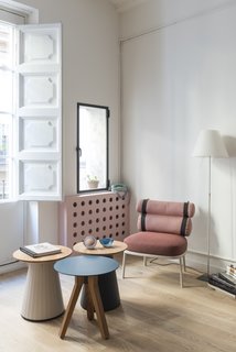 A small side window in the living room that was previously boarded up is now re-opened above the dotted bespoke radiator cover. 