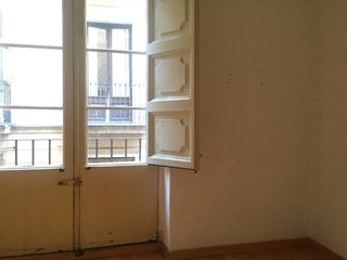 The other large window at the other end of the living room.