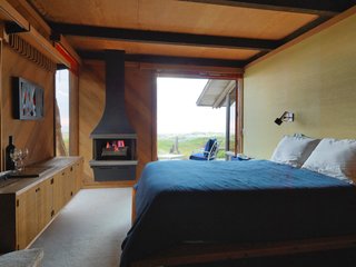 A Contemporary Beach Retreat on California's Central Coast Asks $2.3M - Photo 6 of 10 - The master bedroom has a fireplace perfect for cool evenings. 
