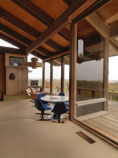 A Contemporary Beach Retreat on California's Central Coast Asks $2.3M - Photo 3 of 10 - A casual eating area off the living room overlooks the deck and stunning views of Morro Bay. 