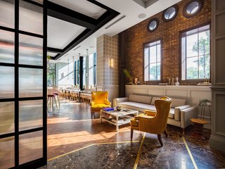 The ground-floor cafe features large street-facing windows and plenty of natural light. 