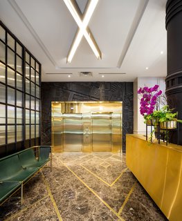 The lobby now houses a vibrant mix of granite and gold. 