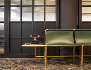 Vintage details—like the antique phone above—herald back to the building's past lives. 