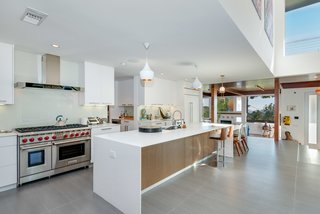 The updated open kitchen features state-of-the-art appliances from Sub Zero and Wolf, and Caesarstone countertops. 