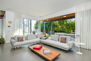 The den opens up to the pool area, enabling Southern California indoor/outdoor living. 