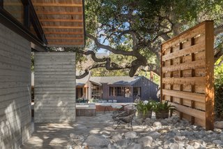 The original structure on the property—a 1957 California Ranch by the acclaimed Kemper Nomland—has been painted black and transformed into a spacious pool/guest house. 