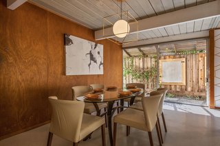 The dining area overlooks an outdoor patio. 