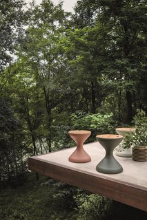 The Bells round side table with an ice bucket insert, also designed by Pedersen, is an elegant, sculptural form with an emphasis on function. 