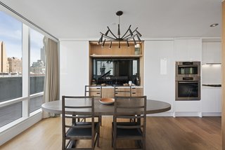 The dining area looks out onto the wraparound terrace. The property houses many state-of-the-art features, including a Creston electronic shade system. 