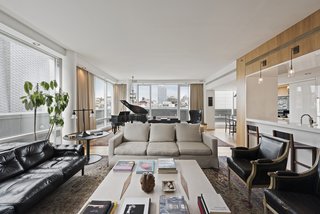 The floor-to-ceiling windows wrap around the penthouse, offering stunning panoramic views.