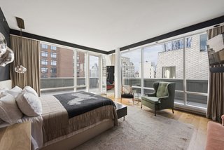 The master bedroom features floor-to-ceiling windows and has terrace access, as well as a deluxe ensuite bathroom.