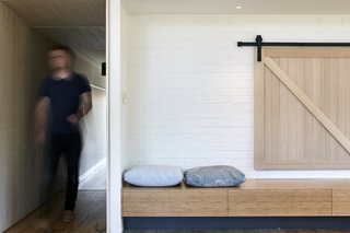 The bench also contains drawers for storage. A sliding panel connects the latest living area to the study. 