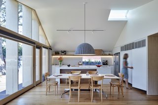 An automated roof window and strategically placed openings at the apex of the slanted ceiling can be opened to release hot air during the summer months. The roof also has white steel sheet lining that minimizes heat gain. 