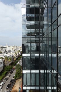 An up-close look at the steel and glass exterior of the modern tower in downtown Tel Aviv. 