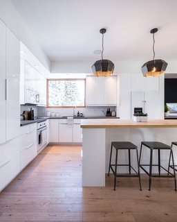 These 30 White Kitchens Are Anything But Ordinary - Photo 13 of 30 - The open plan of the white kitchen helps keep the interiors bright, while also creating a greater sense of spaciousness.