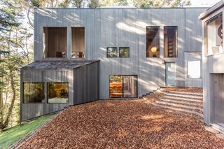 A side view of the main house reveals the vertical board siding typical of Sea Ranch architecture.