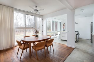 An Eco-Friendly Connecticut Home Wants $650K - Photo 5 of 10 - Wood flooring delineates the dining room area. 