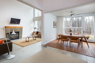 An Eco-Friendly Connecticut Home Wants $650K - Photo 4 of 10 - Meticulous positioning for solar energy keeps the home warm in winter, along with the floor-to-ceiling windows that help heat it during the day. 