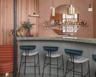 A Historic London Property Is Converted Into a Modern Mediterranean Eatery - Photo 6 of 8 - Assorted brass pendant lighting from Pool hangs over the terrazzo bar. 