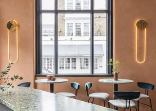 A Historic London Property Is Converted Into a Modern Mediterranean Eatery - Photo 4 of 8 - RA wall lamps from D’Armes illuminate the walls with chic, contemporary style. 
