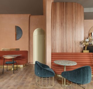 A Historic London Property Is Converted Into a Modern Mediterranean Eatery - Photo 1 of 8 - The circular motif of the sun echoes throughout the design of the modern space, including the shape of the bar, the curved edges of the joinery, and the custom fluted banquette seating.
