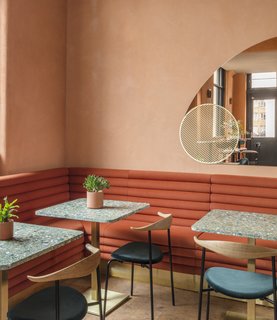 A Historic London Property Is Converted Into a Modern Mediterranean Eatery - Photo 2 of 8 - Custom-made rust-colored tubular suede banquettes accentuate the warm color palette.