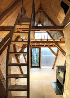10 Buildings We Love by Piers Taylor - Photo 7 of 26 - All of the joinery is crafted from plywood offcuts, including the two staircases. Handrails are made from offcuts of blue rope, leftovers from Invisible Studio's Studio in the Woods program. Both gable ends, "glazed" with high-performance interlocking polycarbonate, afford lots of light.