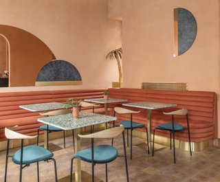 A Historic London Property Is Converted Into a Modern Mediterranean Eatery - Photo 3 of 8 - The dining chairs are from Carl Hansen. Terrazzo tables pick up on the design of the bar which utilizes the same material.