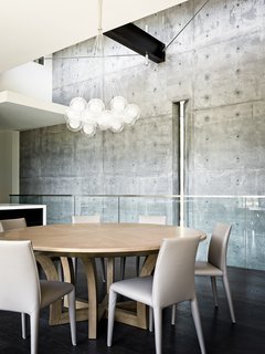 This Concrete Abode Stretches Over Giant Boulders - Photo 7 of 17 - The interior concrete walls echo the ones on the exterior.