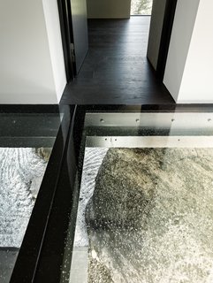 This Concrete Abode Stretches Over Giant Boulders - Photo 12 of 17 - A look at the boulder from inside the home. 