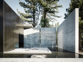 This Concrete Abode Stretches Over Giant Boulders - Photo 2 of 17 - Large concrete walls provide both privacy and shade.