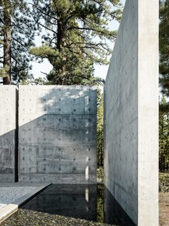 This Concrete Abode Stretches Over Giant Boulders - Photo 3 of 17 - The client requested the design to include a water feature. Instead of a pool that would require tremendous upkeep, the architect was inspired by a pool he saw in Spain to produce a rain channel that is fed by rain and melting snow with a valve that the client can easily control.