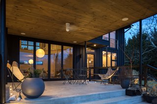 A Renovated Farmhouse in the Hamptons Hits the Market at $2.8M - Photo 3 of 13 - The porch is perfect for entertaining. 