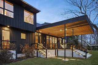 A Renovated Farmhouse in the Hamptons Hits the Market at $2.8M - Photo 2 of 13 - A small patio overlooks the swimming pool. 