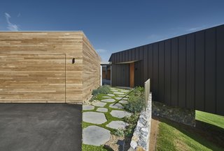 The property also features a wood-clad garage that sits adjacent to the residence. 